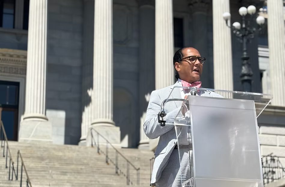 Dr. James M. Thompson I speaking at a podium in front of the South Carolina State House